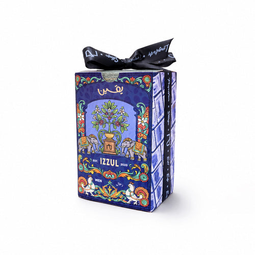 A decorative product box wrapped in blue patterned paper with a black ribbon bow, photographed on a clean white background. The box features colorful illustrated artwork and the visible brand name 'IZZUL'.