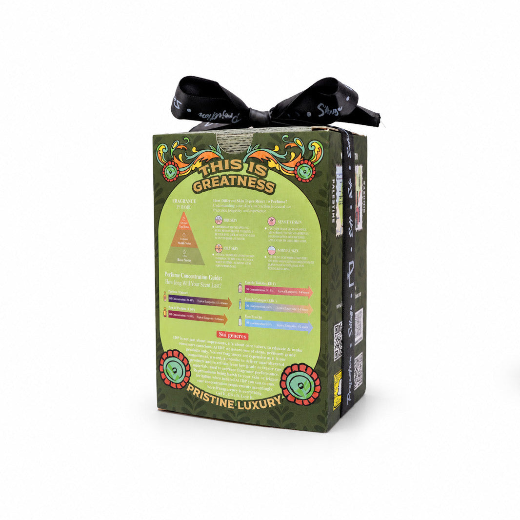 A boxed product package with a black ribbon bow on top, photographed on a plain white background. The front of the box is predominantly light green with decorative graphics, text, and a pyramid diagram, and the side panel is dark green.